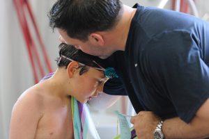 Coach talking to young swimmer