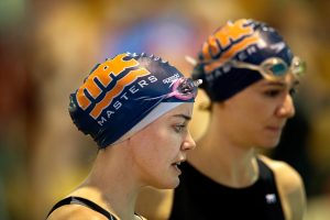 Adult female swimmers with Masters swim caps on